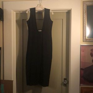 Comme Des Garçons black dress with low cut front.